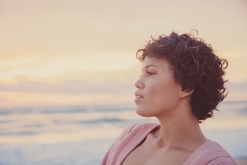 Happy Young Woman on Beach During Sunrise