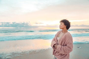 Happy Young Woman on Beach During Sunrise