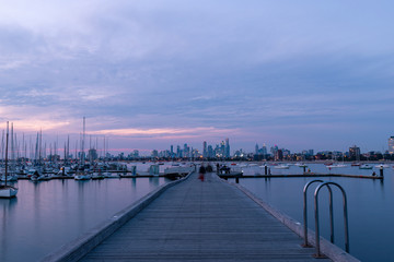 Melbourne skyline, pier, and boats view at dusk time.
