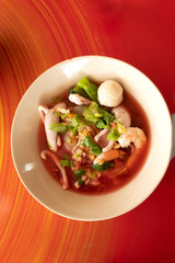 pink seafood flat rice noodles soup on table background,Thai food yen ta fo