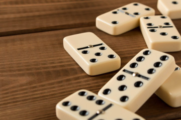 Playing dominoes on a wooden table. Domino effect.