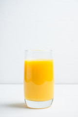 Fresh squeezed orange juice on the rustic background. Selective focus. Shallow depth of field. 