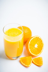 Fresh squeezed orange juice on the rustic background. Selective focus. Shallow depth of field. 