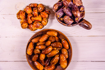 Date fruits on the white wooden table. Top view
