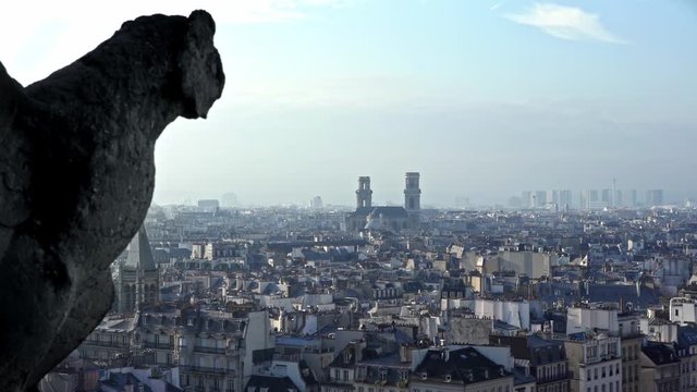 4K, Famous gargoyle statue in Notre Dame Cathedral with city of Paris background. Stone chimera watch over Paris, France. Famous touristic places and popular travel destinations of Europe-Dan