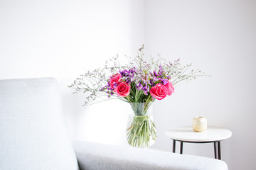 Floral arrangement  of roses and limoniums decorating the living room of the house