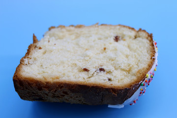 Half Easter cake with raisins on blue background