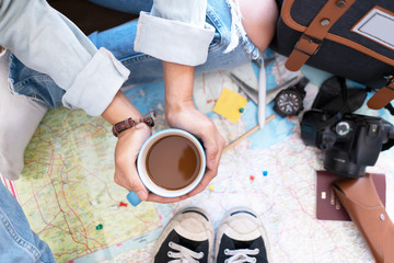 Hand hold coffee and planning for travel