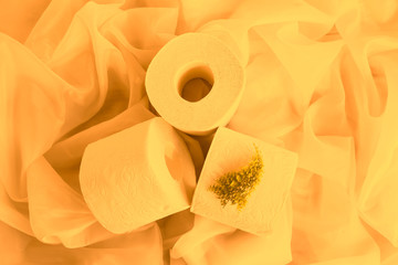 Yellow golden toned. Slightly hazed White toilet paper rolls on drapery cloth. Top view, Closeup. Copy space.