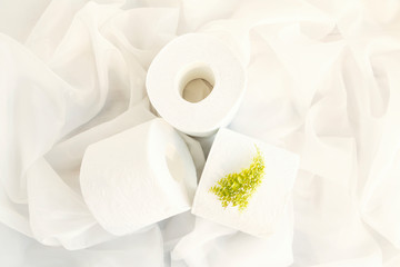Slightly hazed White toilet paper rolls on drapery cloth. Top view, Closeup. Copy space.