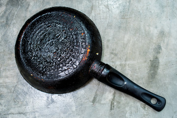 Kitchen utensils a dirty burned pan