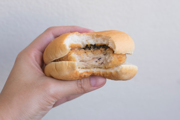 Hand hold a bite burger