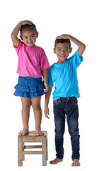 Little boy and girl measuring their height isolated on white background