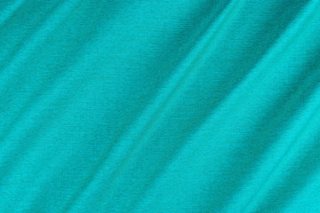 Bright blue fabric texture with folds.