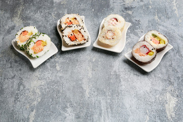 Sushi set on grey stone background.