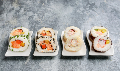 Sushi set on grey stone background.