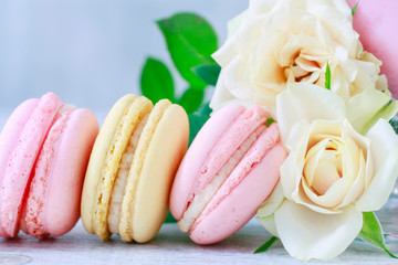French macaroons and yellow roses.