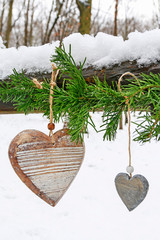 Fir garland with hearts in winter garden