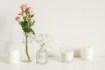 White arrangement of roses, baby's breath flowers and candles. Copy space for lettering