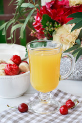 Glass of banana juice and fruit salad on the table.