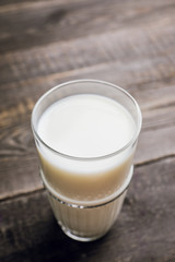 Glass of cold milk on the rustic background. Selective focus. Shallow depth of field.
