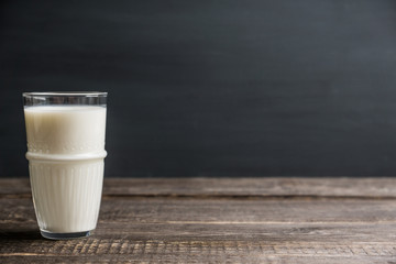 Glass of cold milk on the rustic background. Selective focus. Shallow depth of field.