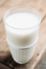 Glass of cold milk on the rustic background. Selective focus. Shallow depth of field.