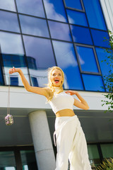 Cheerful fashionable woman in city