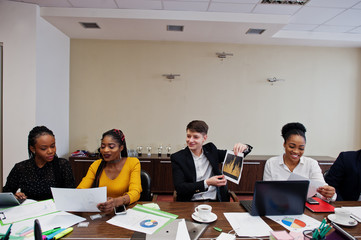 Multiracial young creative people in modern office. Group of young business people are working together with laptop, tablet. Successful freelancers team in coworking.