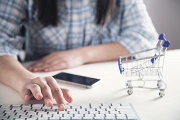 Girl hand using computer keyboard. Online shopping concept