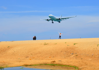 Fototapeta na wymiar Landing aircraft above the beach