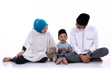 muslim father and mother with son isolated over white background