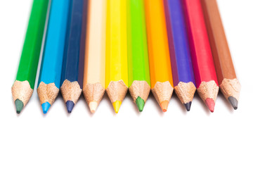 Colored pencils background with a variety of colors. Many different color pencils on white background. Colored Pencils for School or Professional Use.