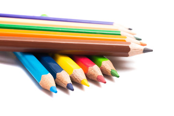 Colored pencils background with a variety of colors. Many different color pencils on white background. Colored Pencils for School or Professional Use.