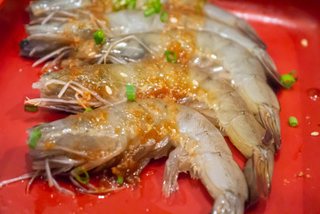 Shrimp stacked on plate in for BBQ grill. Japanese restaurant buffet BBQ grill style.