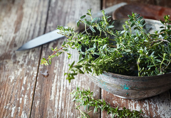 Fresh sprigs of thyme in an old pottery bowl