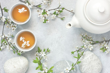 Fototapeta na wymiar Still life with tea cup and cherry blossom flowers, oriental style