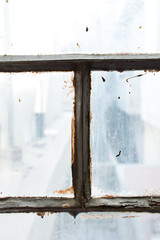 Window of an old house inside view rusted and damaged