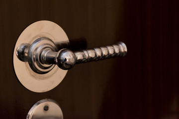 a wooden wardrobe drawer front, metal handle