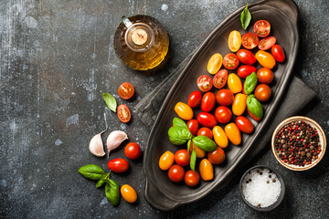 Fresh cherry tomatoes and spices on vintage table