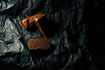 Chocolate candies on a black background