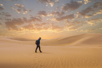 Fototapeta na wymiar A man travel in the desert by walking . 