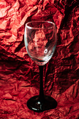 A glass on a burgundy background