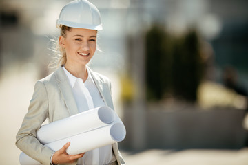 Young ambitious architect. Female engineer with her equipment. 
