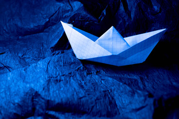 Paper ship on a blue background