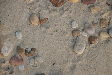 Pebbles on the Fine Sand as a Background