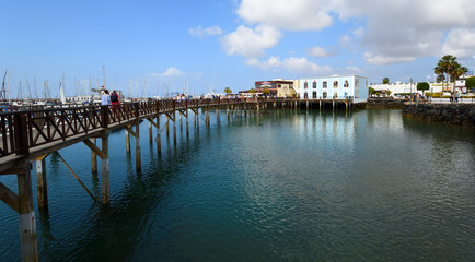 Fototapeta na wymiar Lanzarote, Boardwalk at Marina Rubicon port at Playa Blanca in Canary Islands