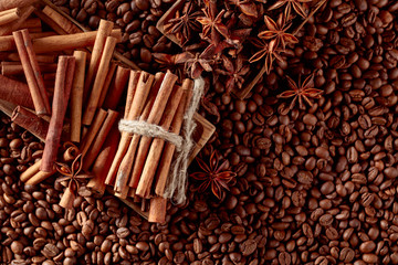 Coffee beans and anise with cinnamon sticks.