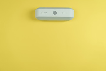 portable speaker on yellow color background