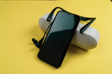 portable speaker on yellow color background